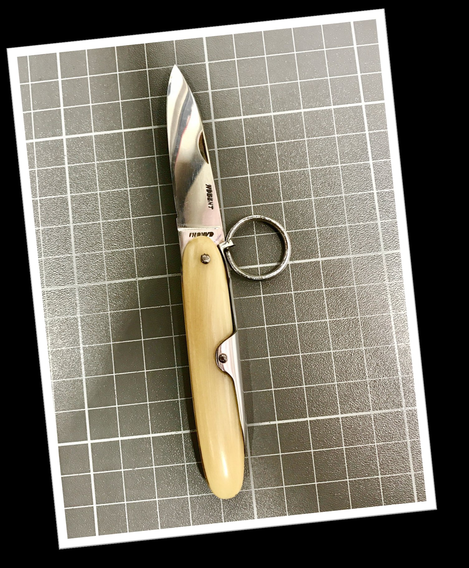 Vintage 1960 Nogent spring-loaded folding knife with blonde horn handle and chrome steel blade
